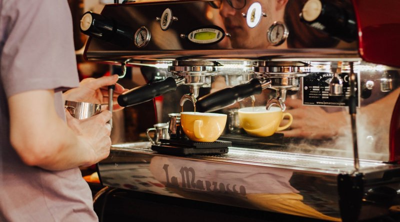 person using espresso machine